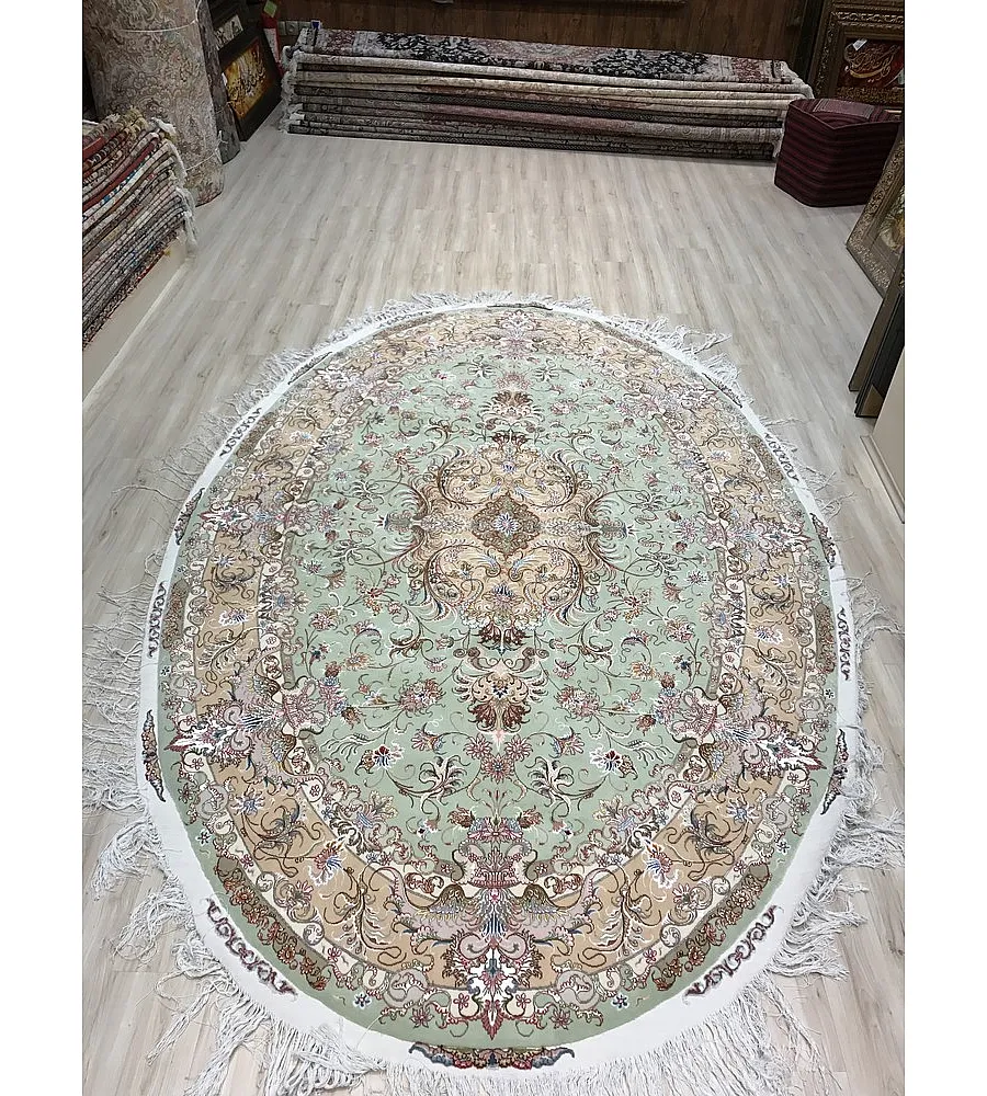Handmade oval Tabriz rug, intricately designed, crafted in Iran, luxurious Persian carpet for home decor or living spaces.