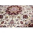 Handmade rug with circular design from Tabriz, Iran; intricate patterns, high-quality craftsmanship, perfect for home decor.